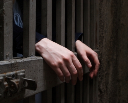 Hands-Coming-THrough-Jail-House-Criminal-Investigations-495x400